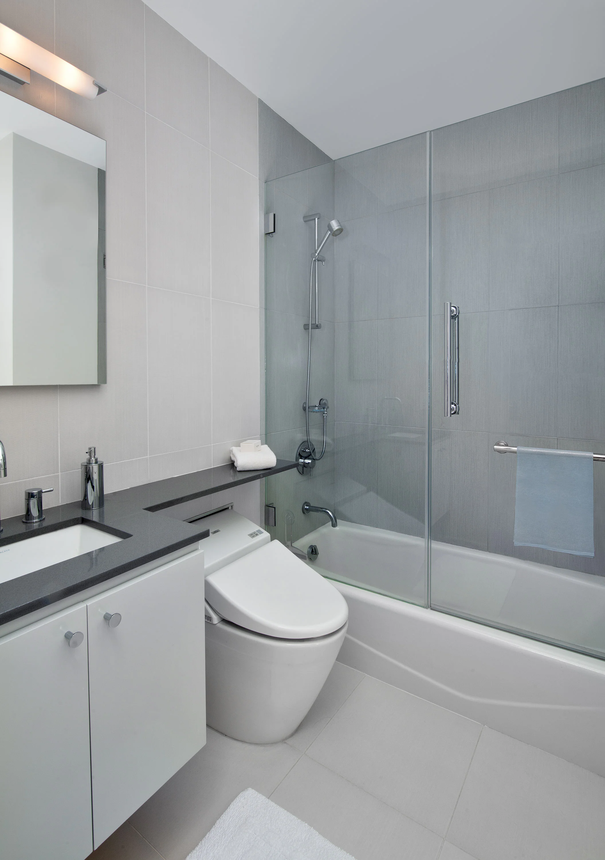 The bathrooms have a clean look — with simple tile and textured wallpaper that create subtle contrast.