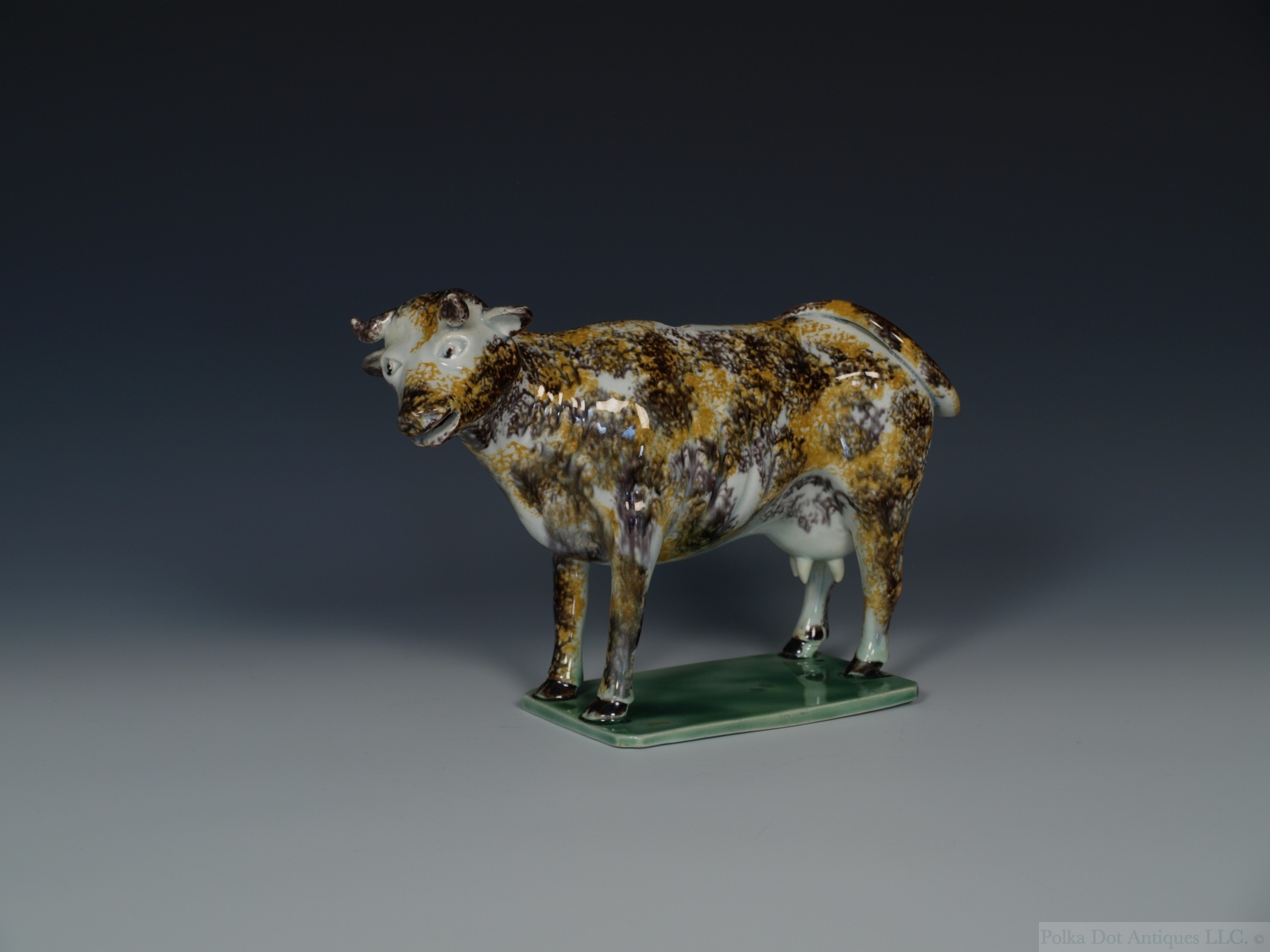 A Staffordshire Pearlware Cow Creamer, c.1800, sponged in ochre and manganese, lacking cover.