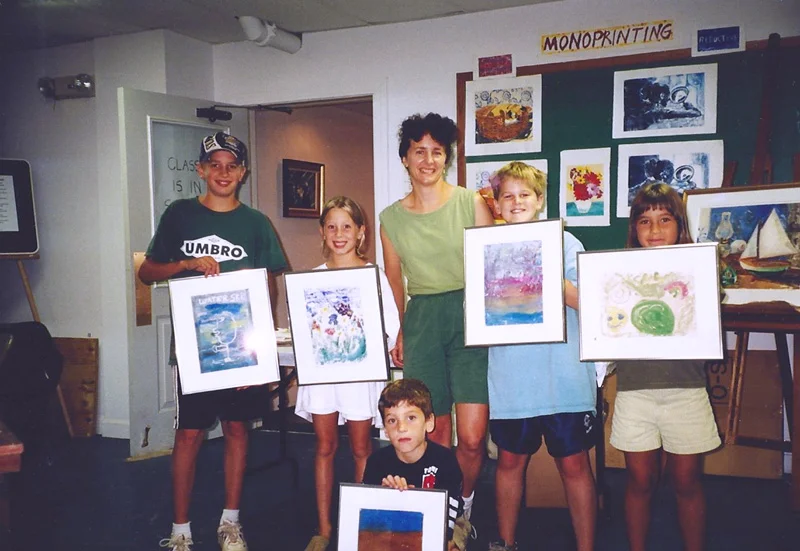 Teresa Baksa with Explorers of The Art World students, Cape Cod Museum of Art, Dennis, MA, 2000. This monotype workshop concluded with each child learning the proper way to frame and protect a work of art.
