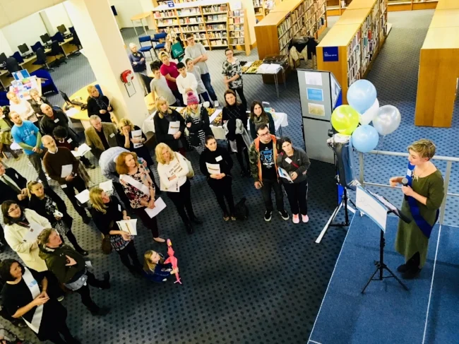 Beth Moore, College Manager, addresses supporters at their first anniversary party