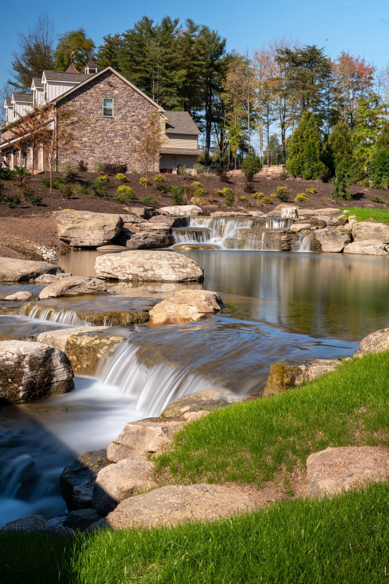 a-welcome-home-large-pond-waterfalls-boulders.jpg