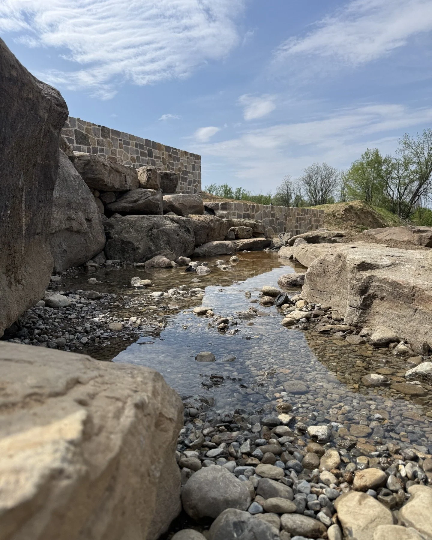 She&rsquo;s starting to take shape. 💦
We&rsquo;re not done yet &mdash; but we couldn&rsquo;t resist filling the lower sections to get a feel for how this thing is going to flow. Testing begins next week on our Chester County, PA pondless waterfall b