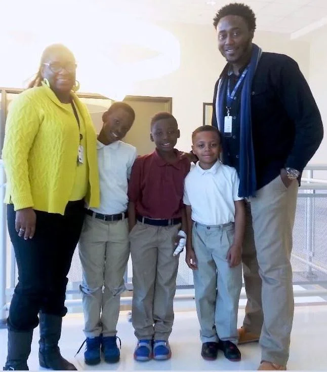 Memminger Parent Advocate Darcell White and Student Support Specialist Raymond Nelson with third-grade students Thomas McWhite, Jaycee West and Tzion Camera.