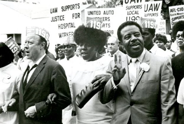Rev. Ralph Abernathy, President of the Southern Christian Leadership Conference, right, marches with Local 1199B President Mary Moultrie and United Auto Workers President Walter Reuther during local hospital workers' strike in 1969. PHOTO CREDIT: Avery Research Center, College of Charleston.