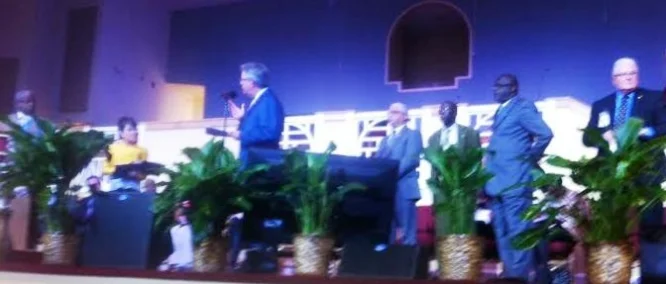 Charleston Mayor John Tecklenburg, in center with hand raised, answers CAJM's Rev. Nelson B. Rivers III, while four City Council members wait their turn.