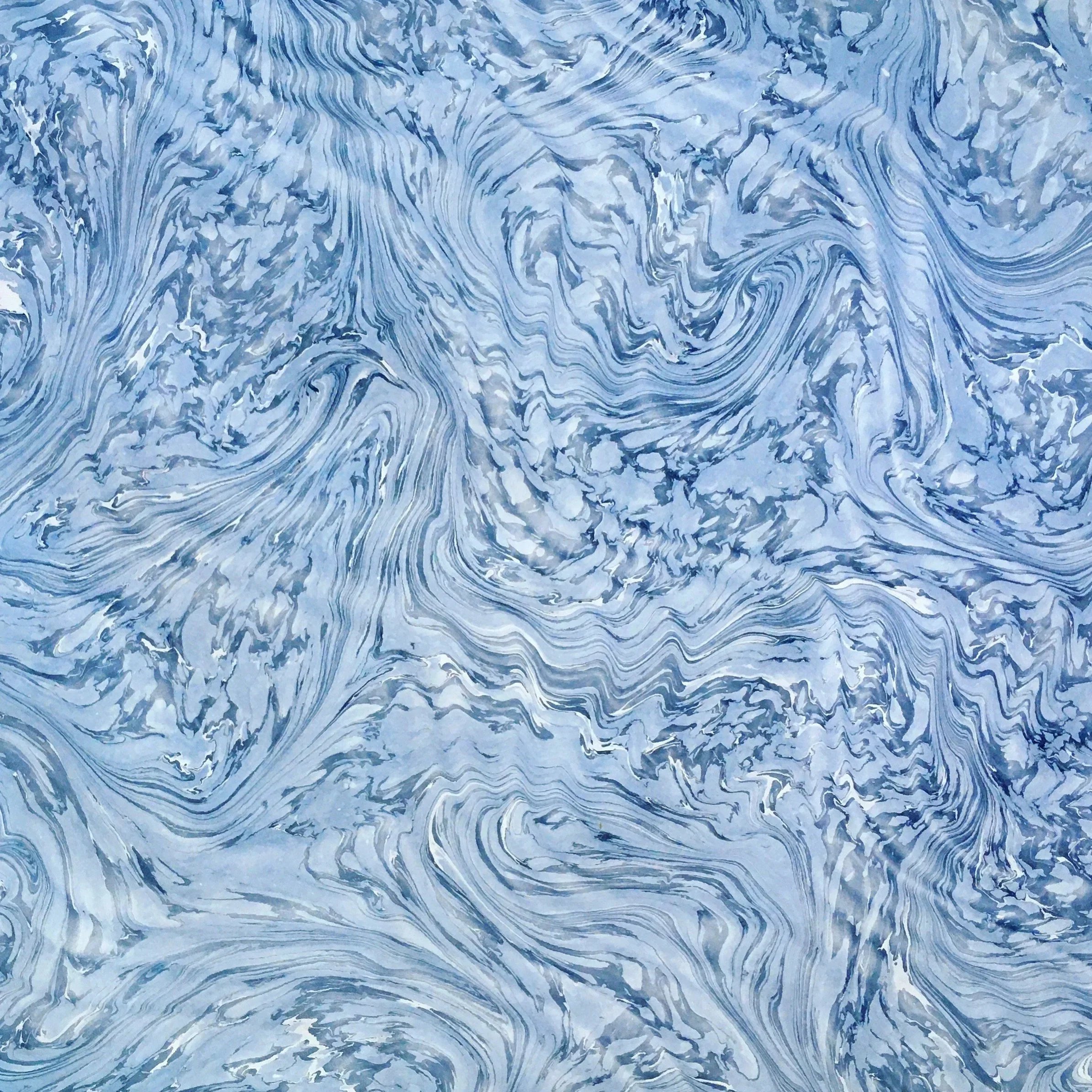 a marbled design of undulating indigo on a white ground blue