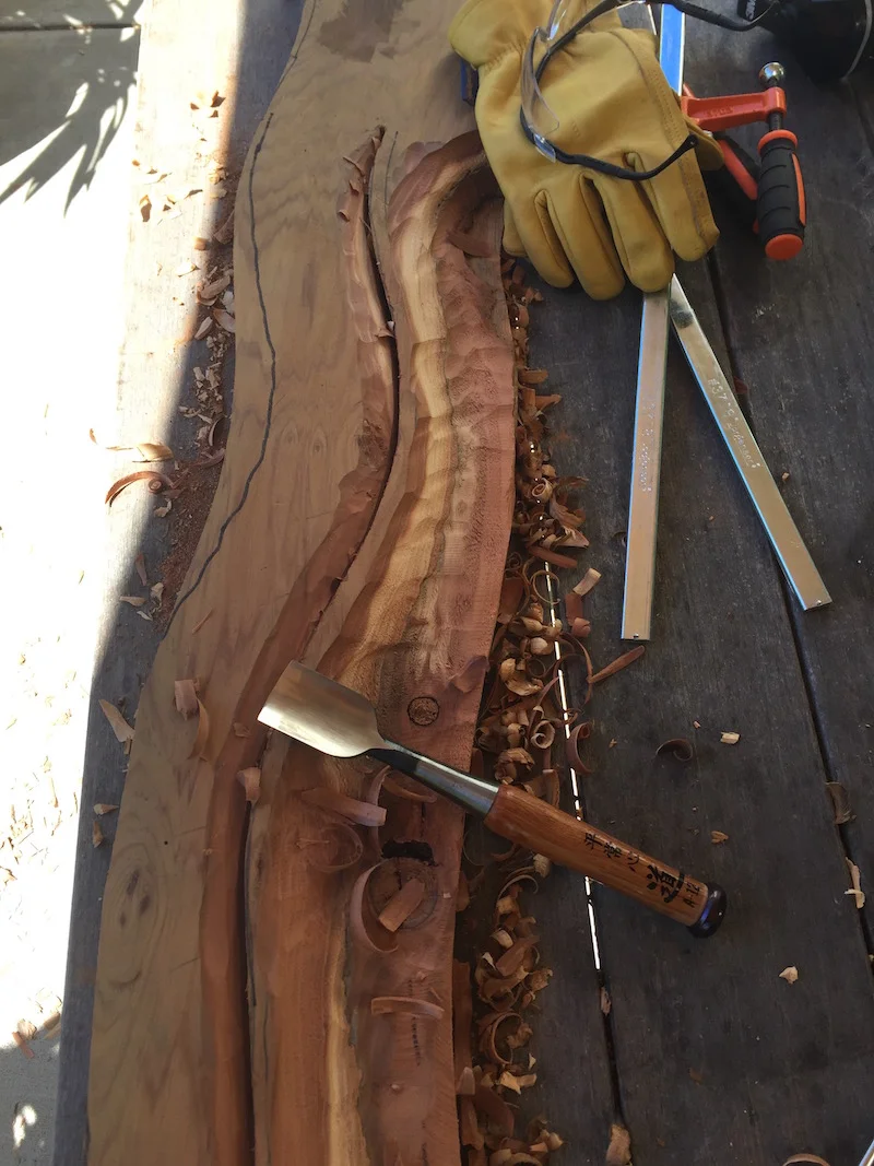 Using a Japanese wood chisel to carve the wood