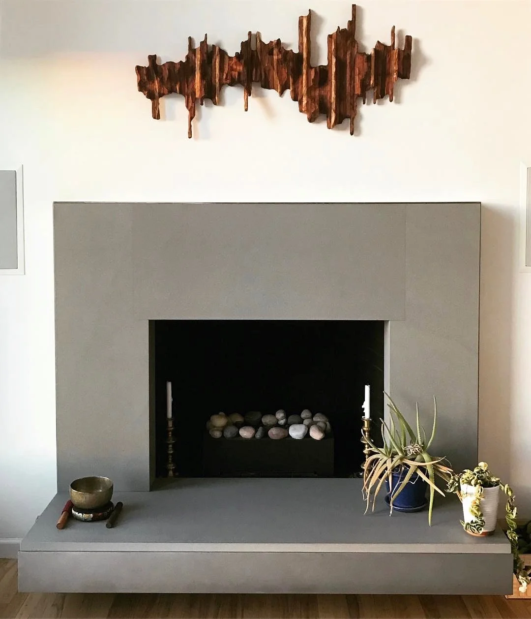 Wooden wall art "Mountain Ridge" above a fireplace mantel as an idea for interior design