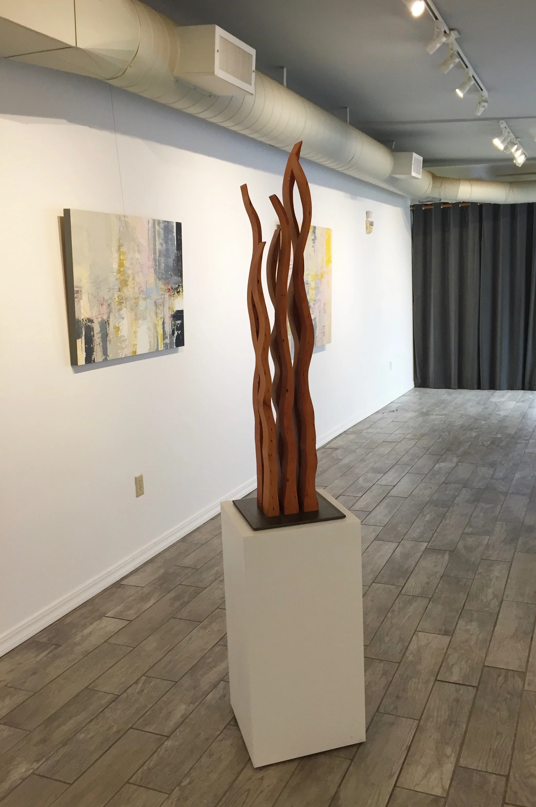 Contemporary sculpture “Dancing Flames” made from reclaimed wood at Desta Gallery in San Anselmo