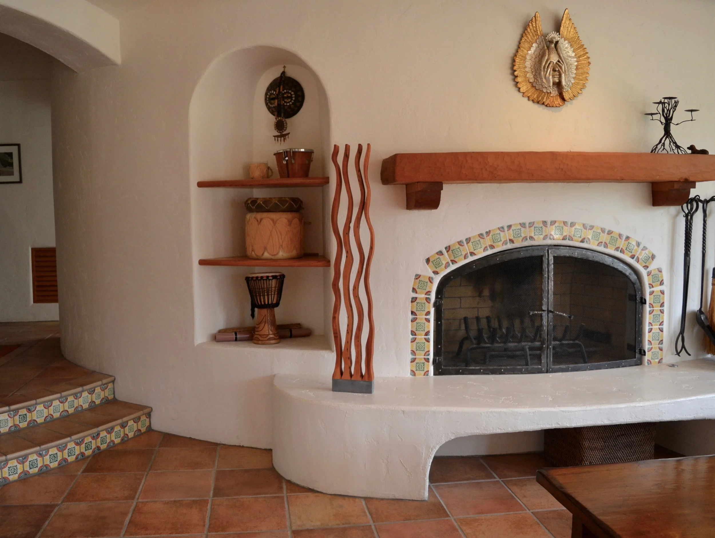 Wooden sculpture “Four Dancers” next to fireplace in a Orinda residence
