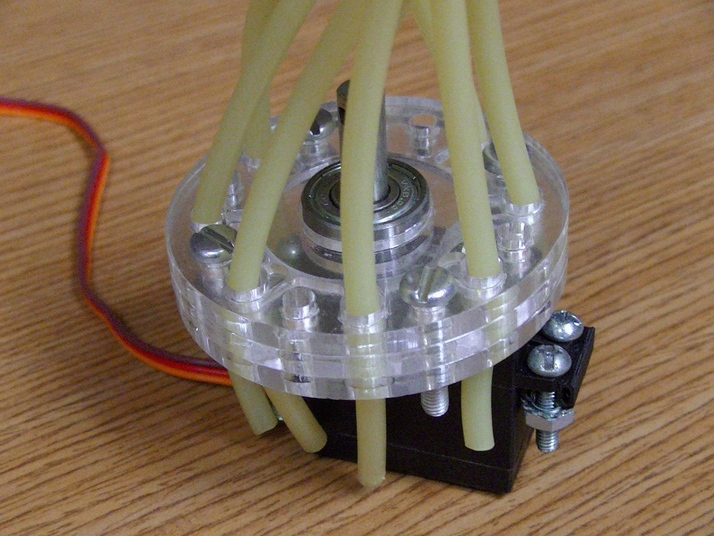   An acrylic prototype of the multi-valve   As liquid flows in from the manifold above, the cam within the main disk rotates, opening one port at a time. This version was able to restrict flow 100% at pressures up to 80 PSI. I believe that with furth