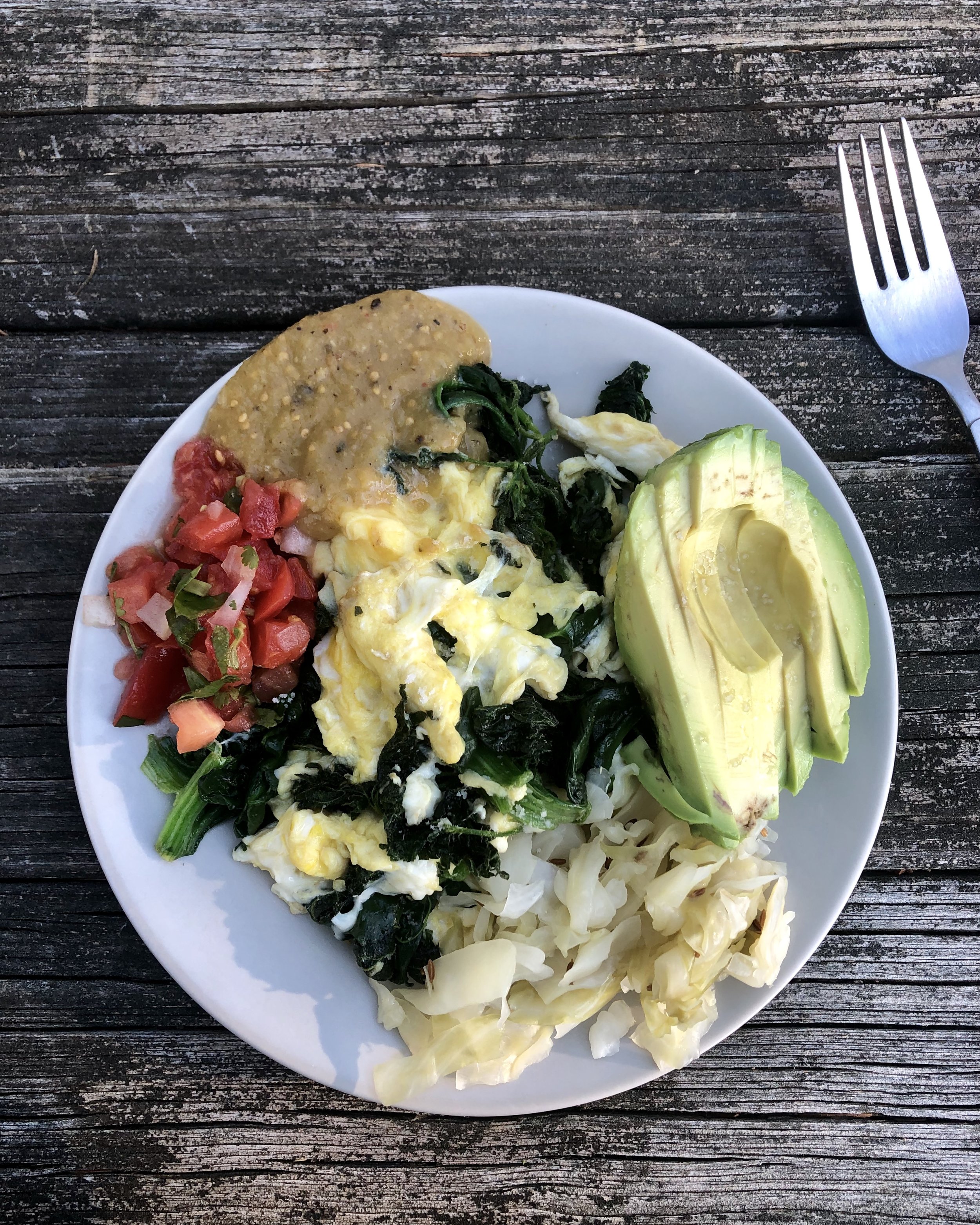 Scrambled Eggs & Nettles with avocado, 2 salsas, and sauerkraut—a nourishing and filling breakfast!