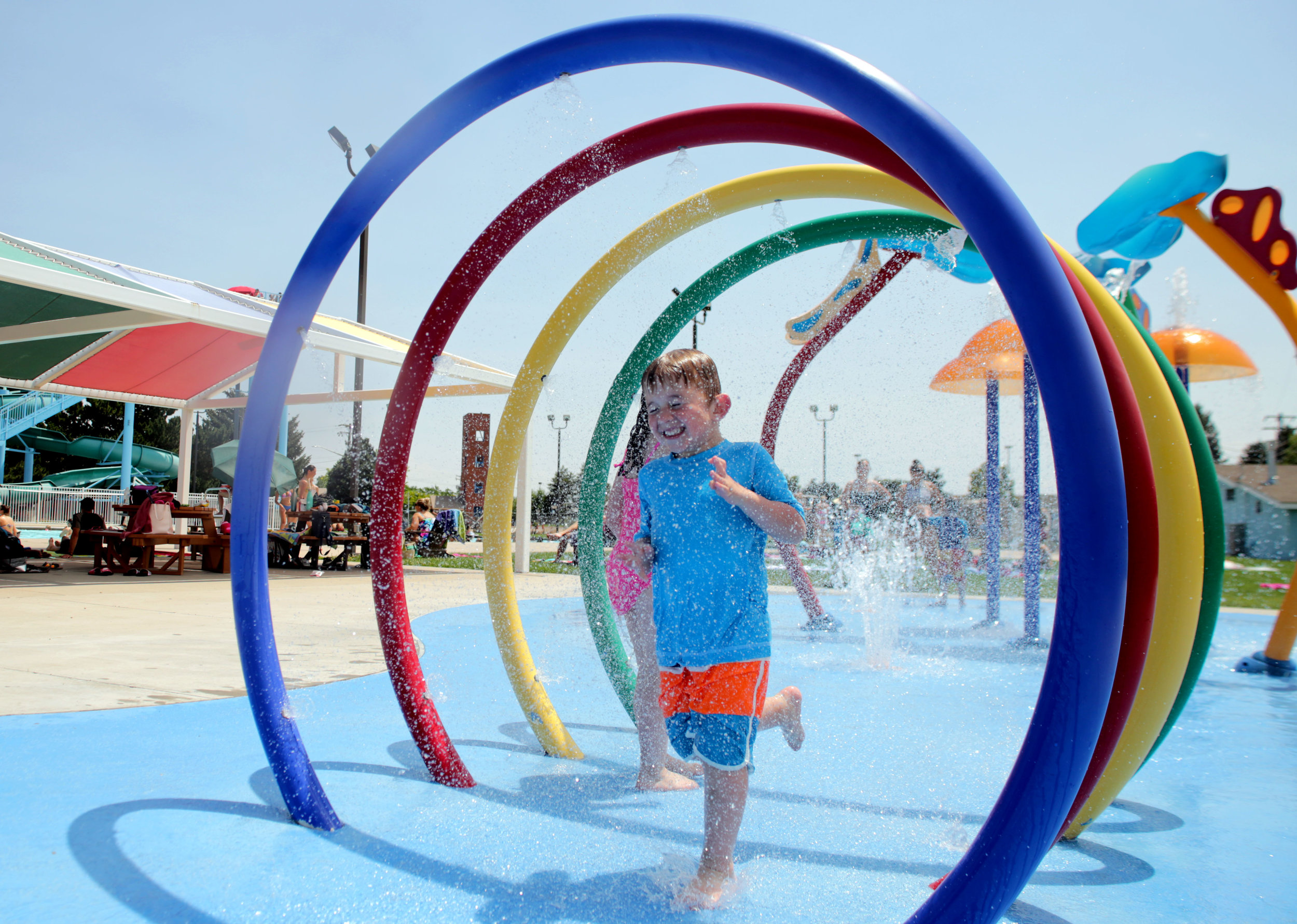  Everett Lewis, 4, runs through waterpark rings at the Centennial Outdoor Pool, 2315 Reservoir Rd., in Greeley, July 2017. Lewis came to the park with his mom and siblings in an attempt to get a break from the heat. According to the National Weather 