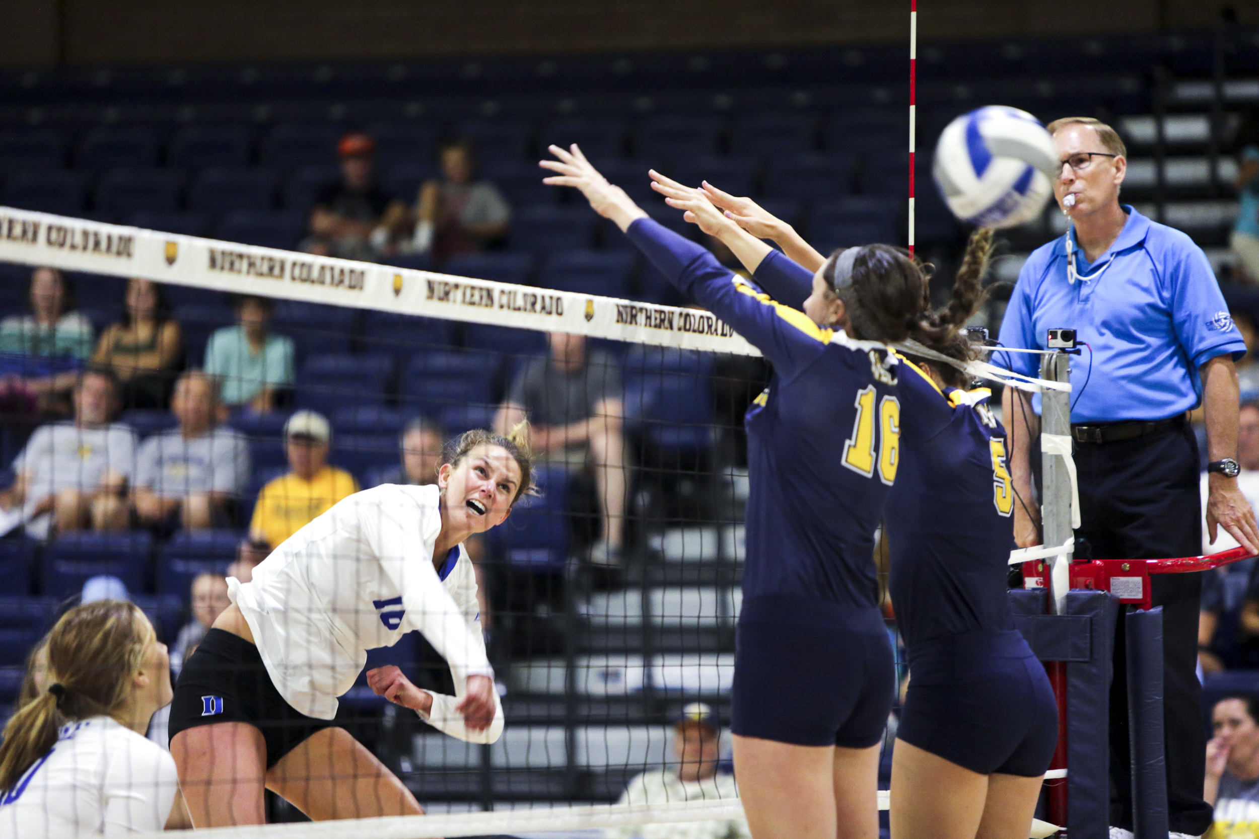  Duke University's Cadie Bates spikes the ball over University of Colorado's block during a volleyball game on Saturday at the Bank of Colorado Arena in Greeley, Colorado. 