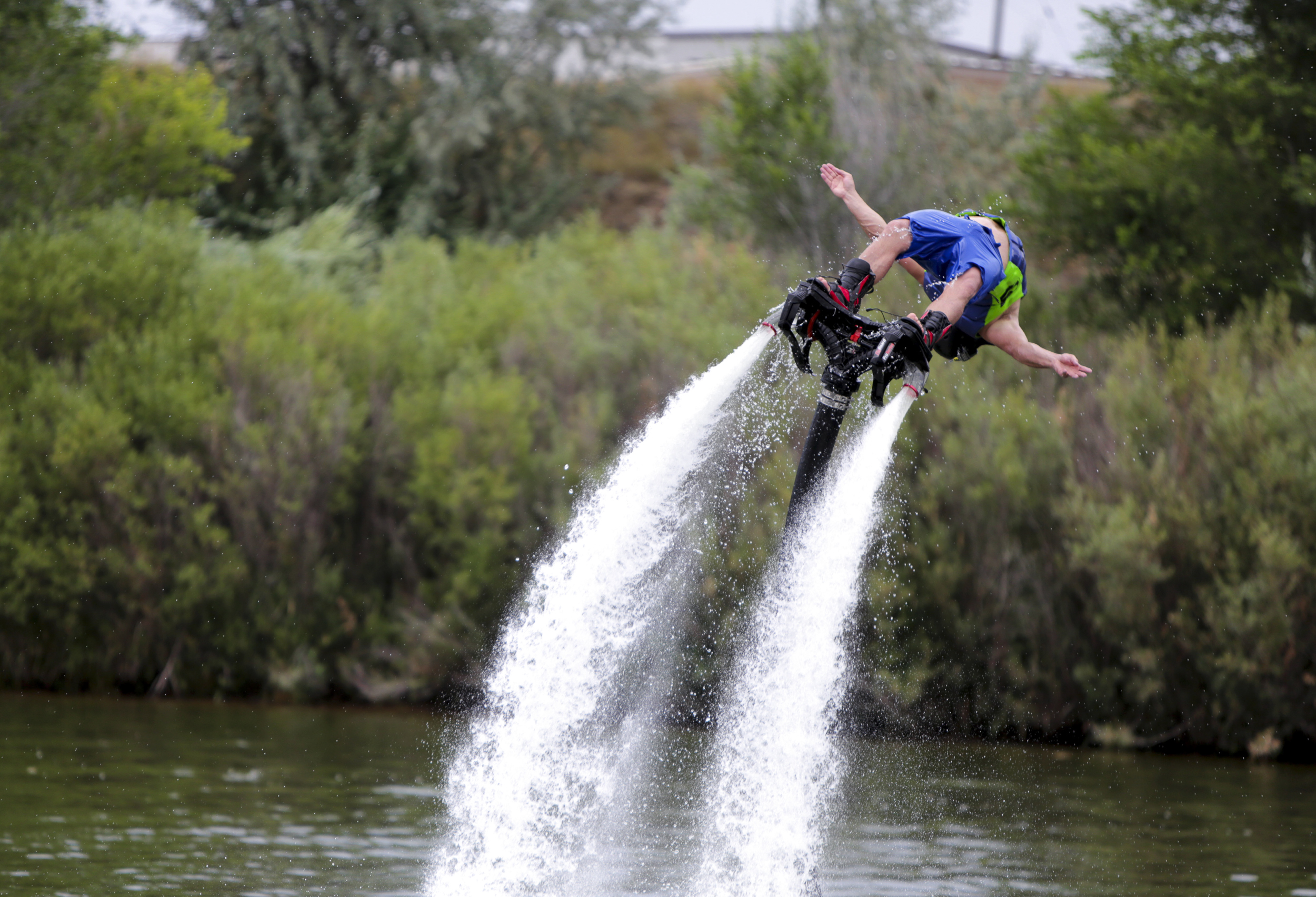  Chris Hock does a backflip on a fly board during the Bridge the Gap wakeboard and waterski tournament on Saturday at Madison Lake in Greeley, Colorado. The purpose of the event was to honor Scott Barone a wakeboarder who passed away. Additionally th