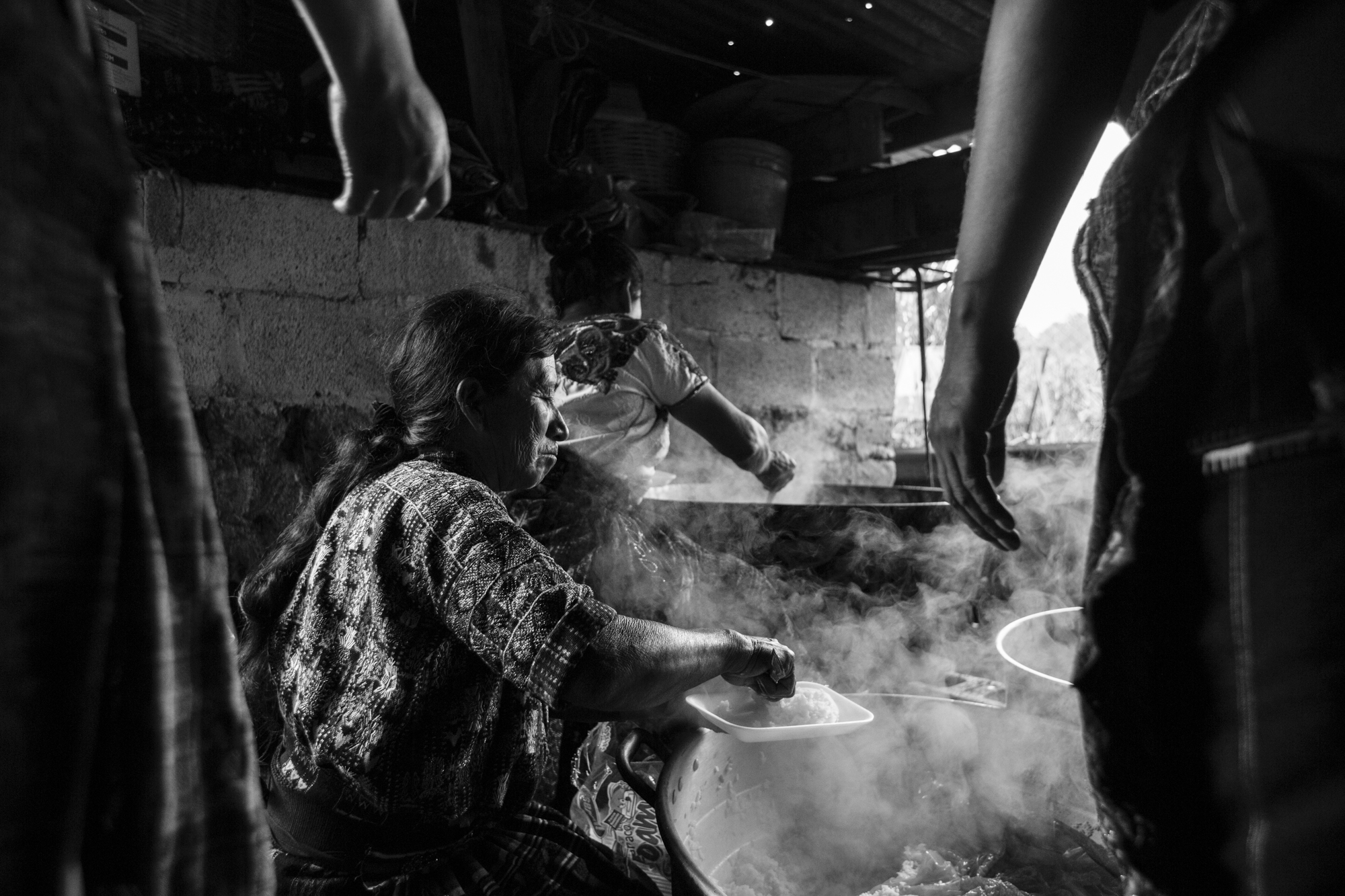 Women cook Pepián, a traditional Guatemalan dish, in a smoke filled area, for the guests of Jorge Mario’s wedding in Sololá, Guatemala.