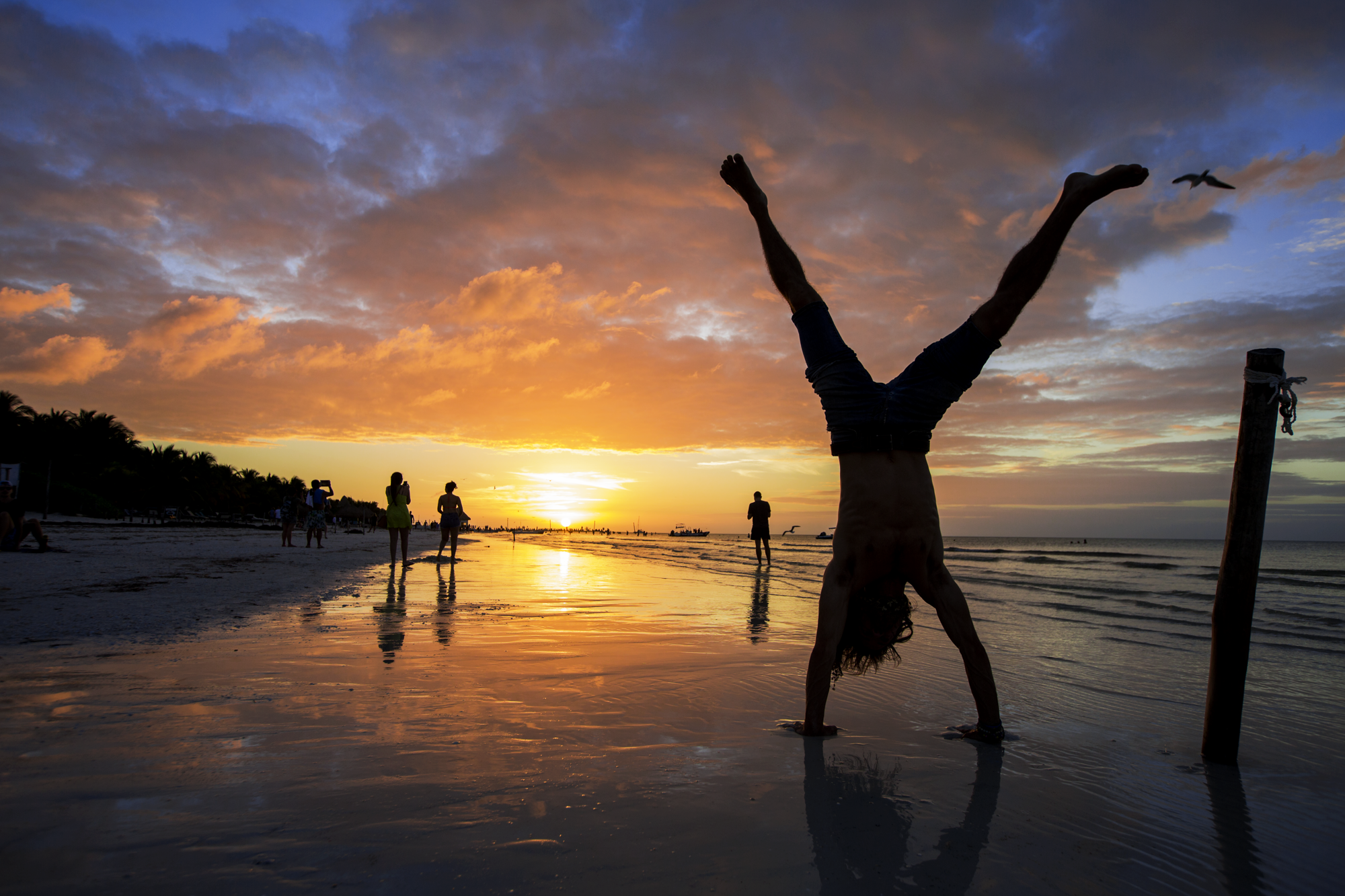 Jason Gegere does a handstand as the sun sets in Isla Holbox, an island north of Mexico’s Yucatán Peninsula, on December 29, 2018.
