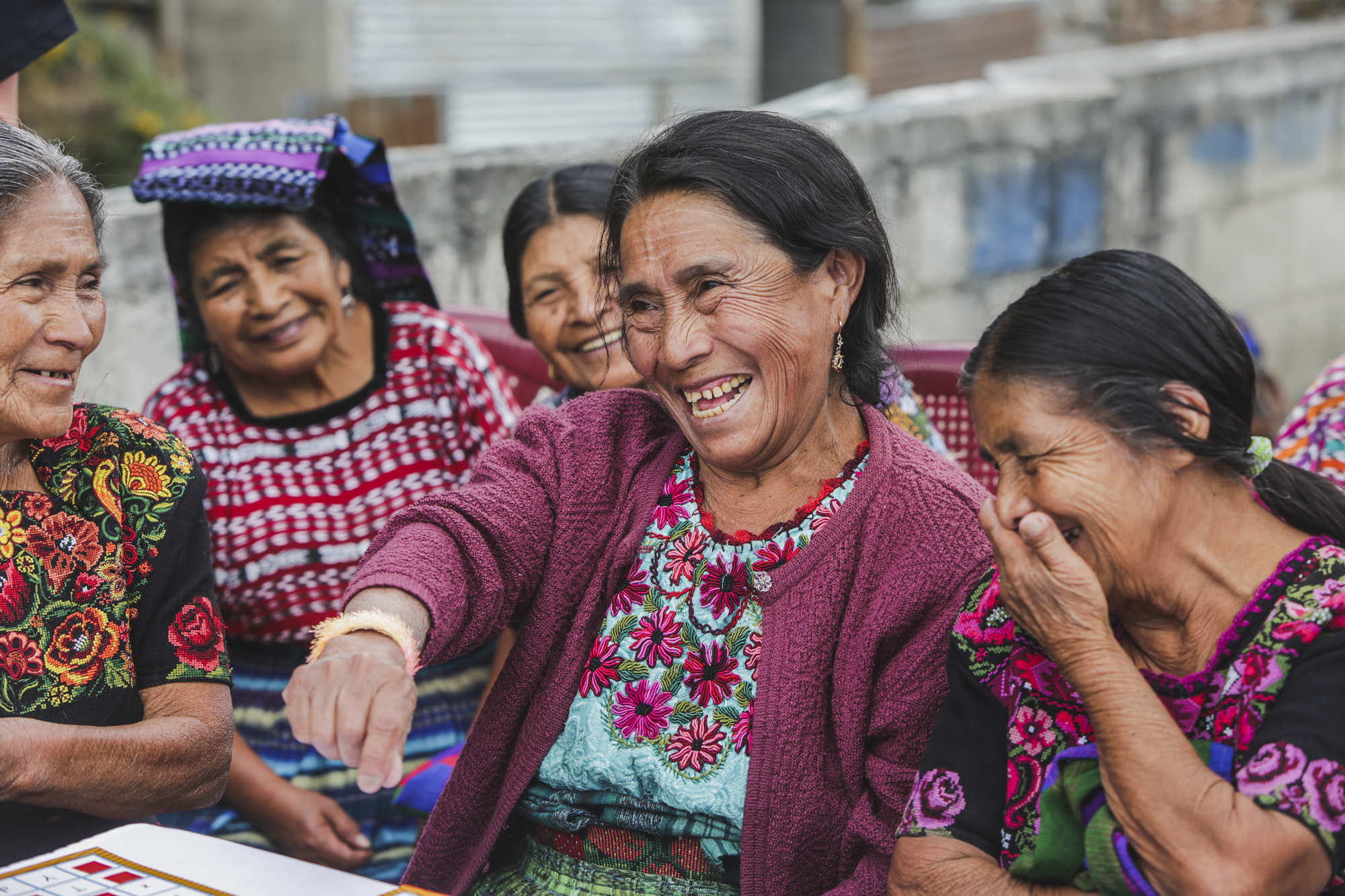 A group of women smile and laugh during a game of bingo at an elderly care center in Patanatic, Guatemala, on January 10, 2019.