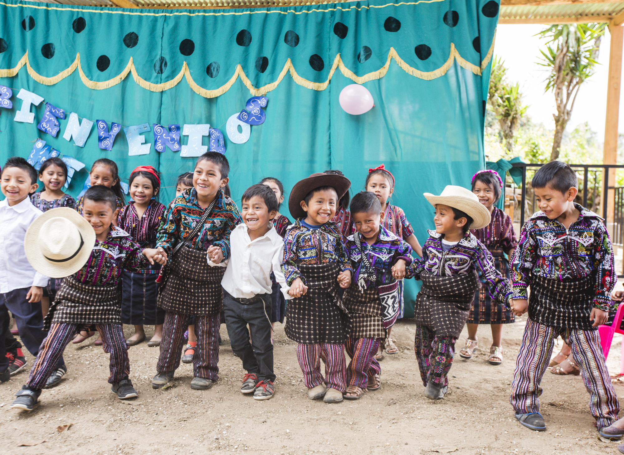 Children do a traditional Maya dance at their preschool in a small community, Peña Blanca, Guatemala, on November 23, 2018. These students are wearing traditional traje (clothing) which is an essential aspect of the Maya culture. Traje is unique for its storytelling function, as each color and stitch cultivate imperative meanings. Garments serve as an expression of both identity and geography.