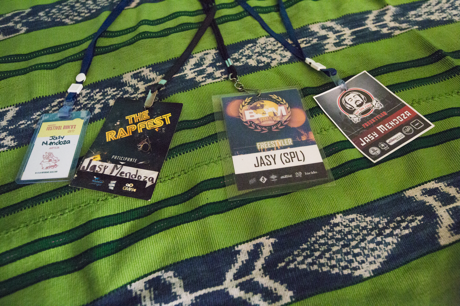 Detail shot of badges on Jasy Mendoza’s bed, from some of the hip-hop events he has attended.