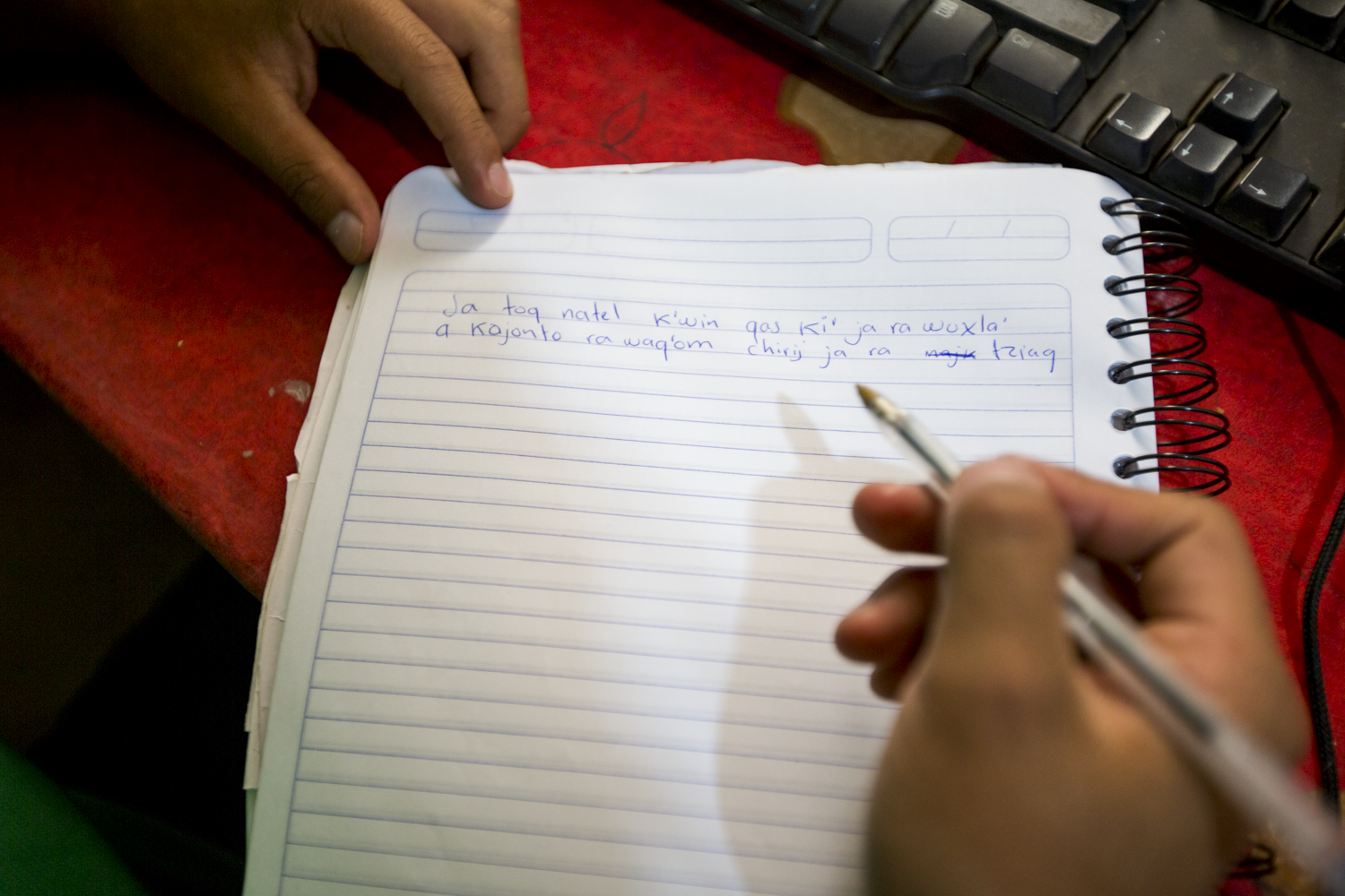Jasy Mendoza, 23, member of Poesía Loca, writes lyrics to a song in Tz’utujil on December 22, 2018. Poesía Loca raps using a combination of Tz’utujil and Spanish in their music.