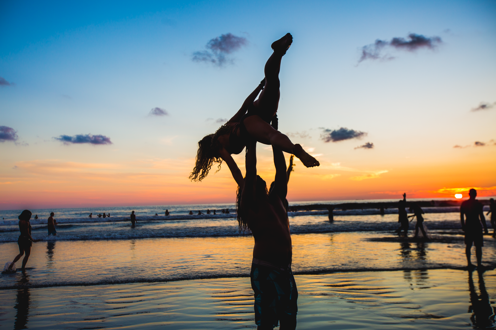 A couple does yoga on Uvita Beach in Costa Rica, during Envision Festival on March 2, 2019.