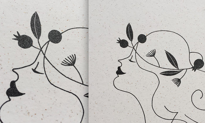 close up showing speckled paper and metallic ink