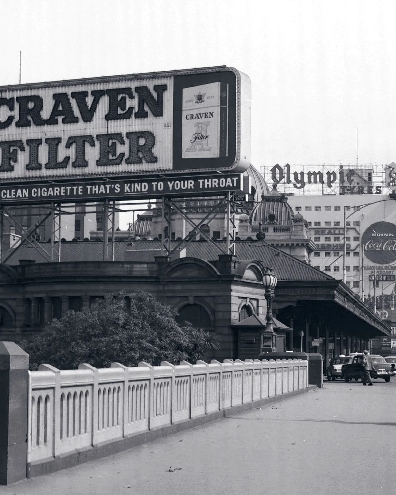 Flinders Street in black and white!
Before the advent of digital billboards Flinders Street was home to amazingly crafted signage and billboards. 
Craven Filters, Coca-Cola and Olympic Tyres. Advertising relics once standing tall in the surrounds of 