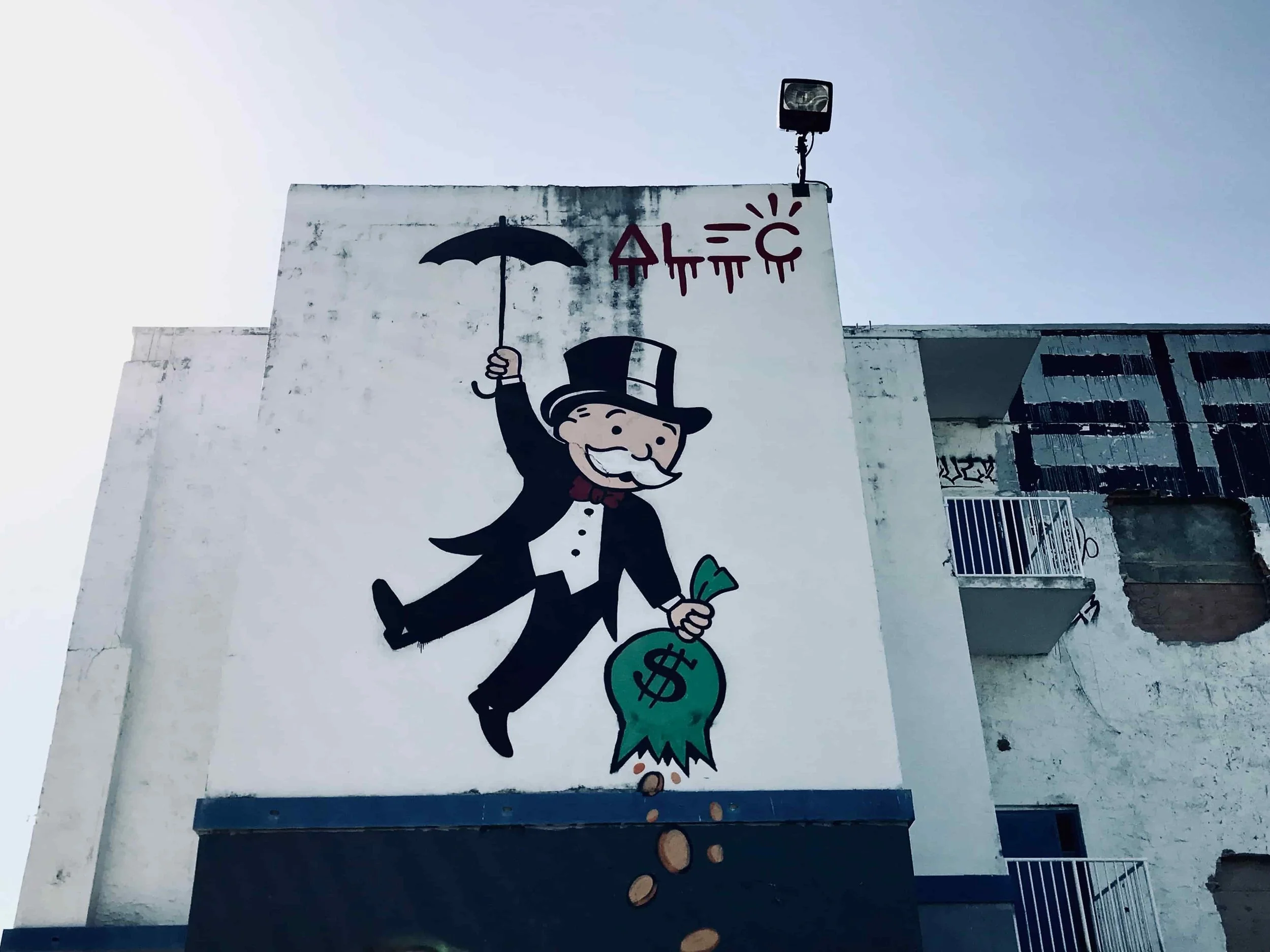 Mr. Monopoly is flying like Mary Poppins dropping $$