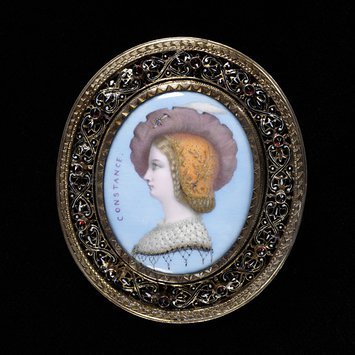 Paris, c. 1862 Brooch, painted porcelain plaque, inscribed, open silver mount with enamel decoration, set with garnets. V&A Museum