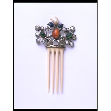 England, 1906 Hair comb, ivory, mounted in silver and set with mother-of-pearl, sapphires, green stained chalcedony and a fire opal matrix (Arts & Crafts) V&A Museum