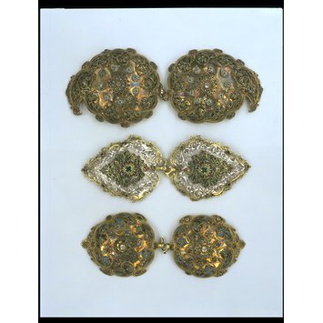 Cyprus c. 1750-1850 Clasps, repousse and cast silver, partly gilded, with black and green filigree enamel and red and green pastes V&A Museum
