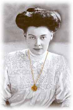 Late Victorian lady with gold chain and watch.