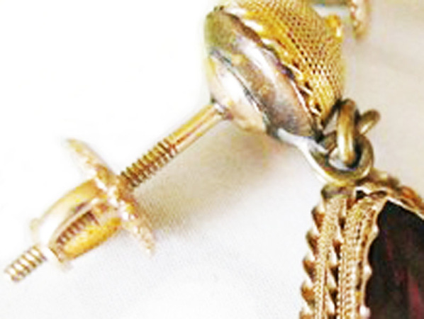 Detail of screw-back earrings.