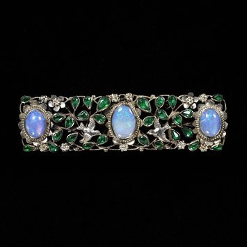 Gaskin, Georgie Cave, 1868 – 1934 (designer) Brooch, Silver wire, opals, glass imitating emeralds V&A Museum