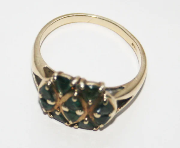 A naturally mined Alexandrite and 9 ct English ring from my personal collection. Judging by the Art Deco setting, I would place this ring from 1920 to 1940. It was hard to capture the colors with my camera, but the stones change subtly from dark green to dark purple in daylight.