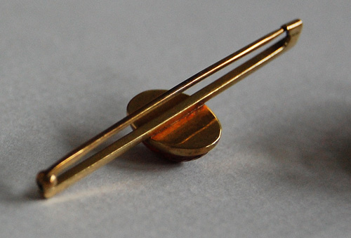 Art Deco era brooch with body attached to a large safety pin style fastener. 