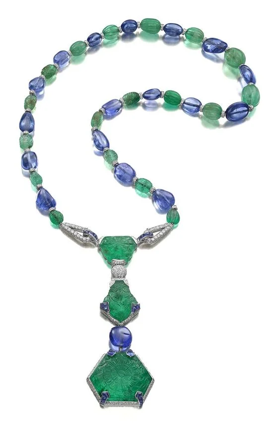 The Cartier Timken necklace, designed in 1925. It is one of the most important examples of Cartier jewellery from the Art Deco era. It is set with three rare Mughal emeralds carved on the front and reverse weighing 71.91ct, 30.27ct and 29.21ct, sapphire beads, buff-top cabochon sapphires, emerald beads and diamonds