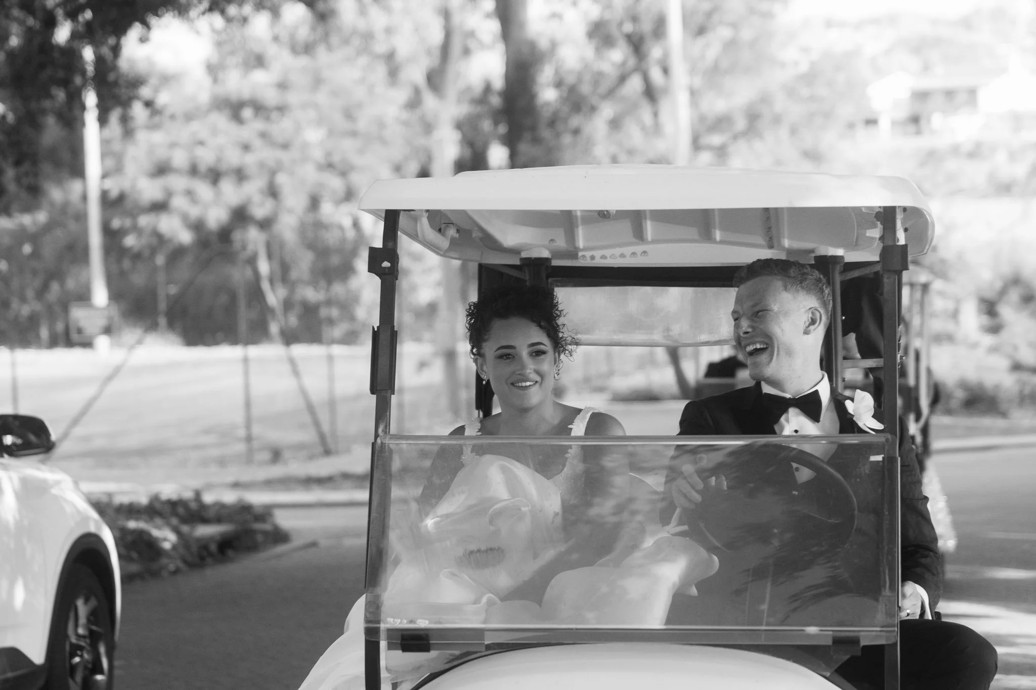 bride-groom-laughing-golf-cart-wedding-photographer.jpg