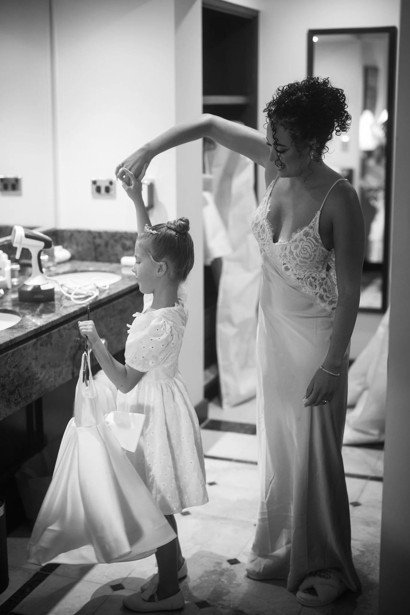 bride-and-flower-girl-getting-ready-wedding-photographer (1).jpg