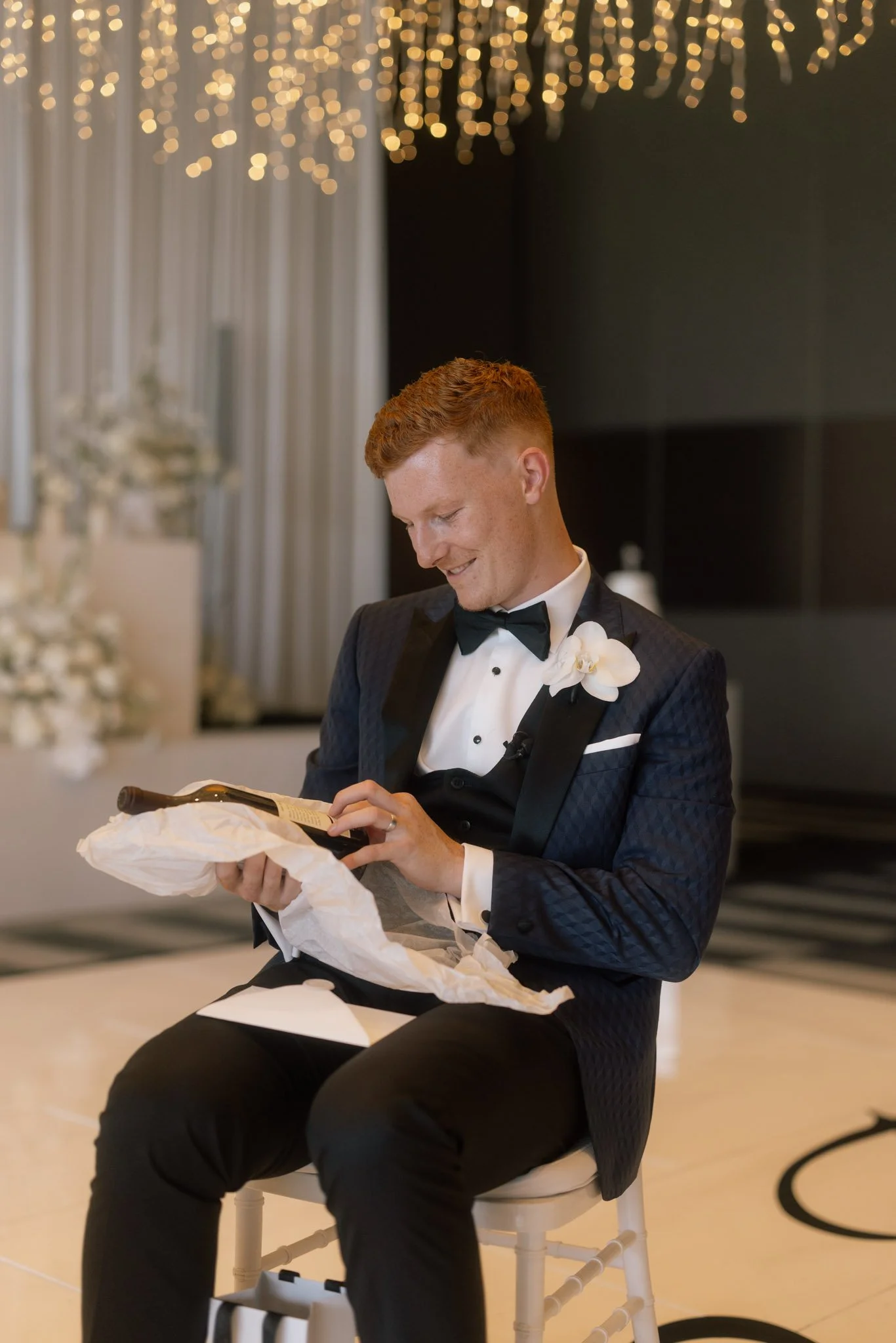 groom-opening-gift-wedding-photographer-videographer.jpg