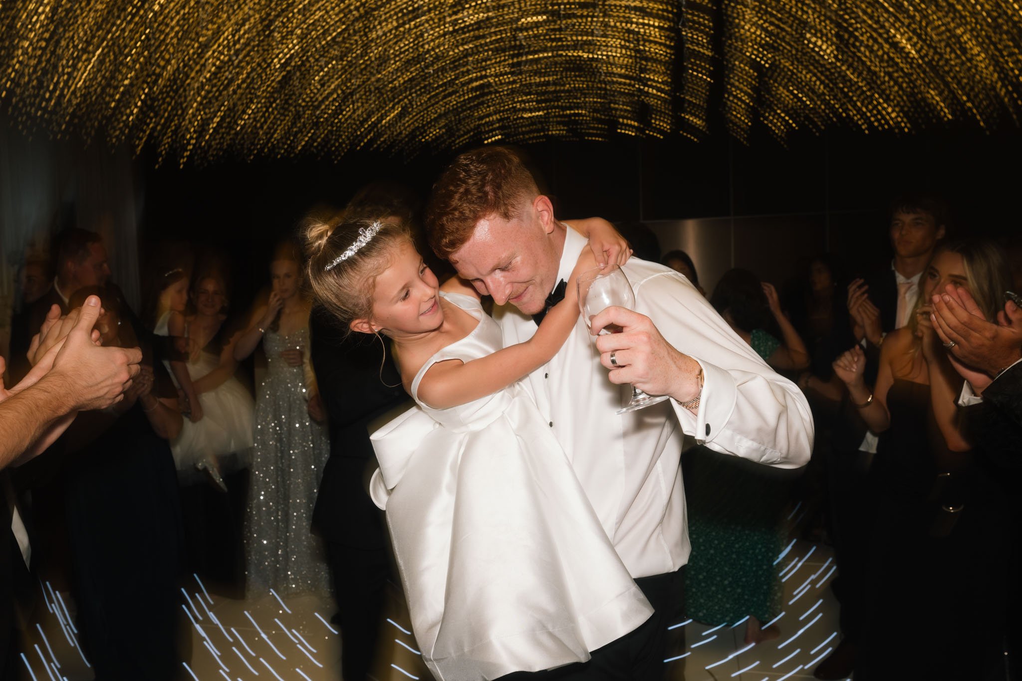 wedding-photographer-captures-man-dancing-with-flower-girl.jpg