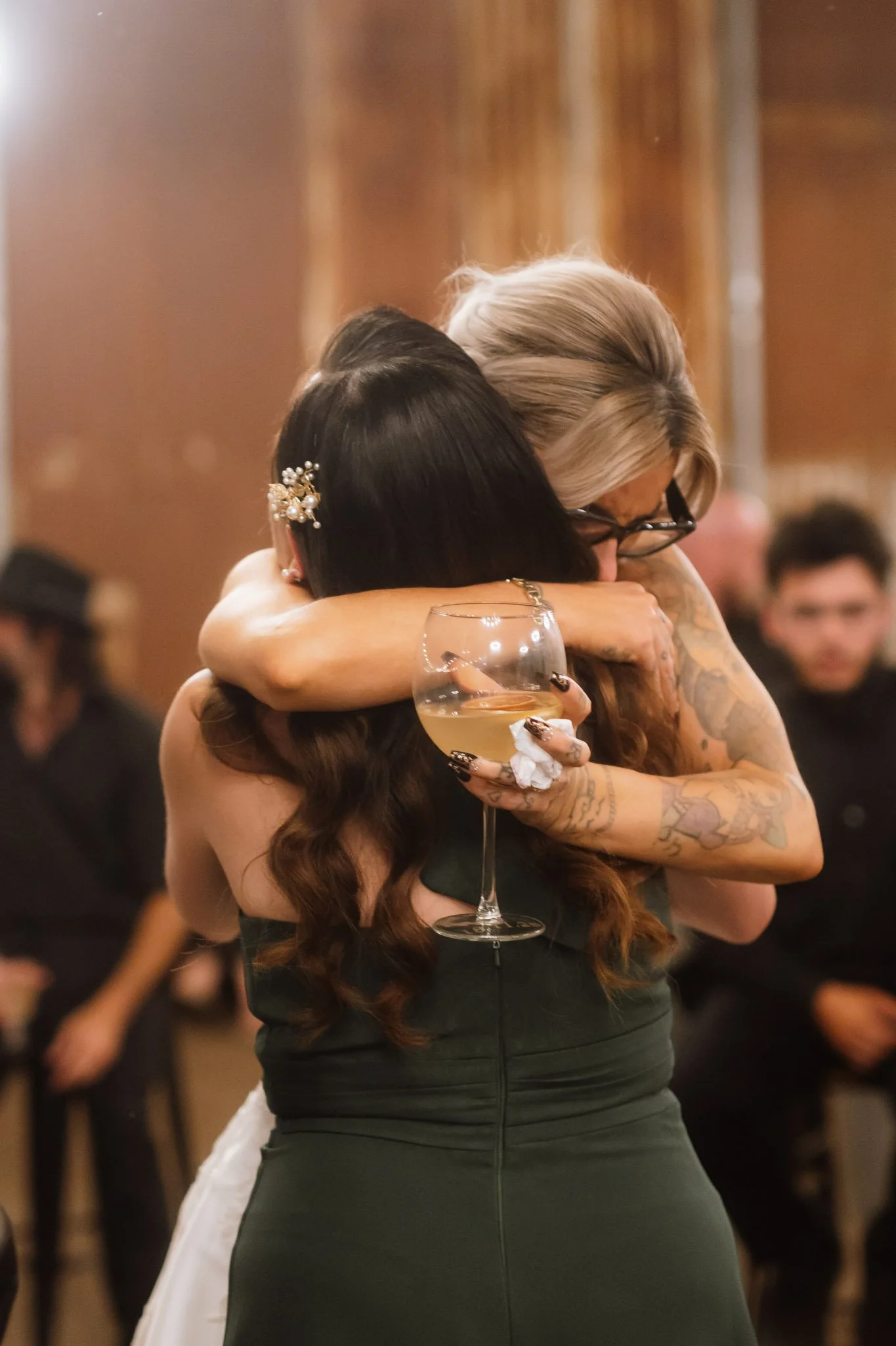 A heartwarming, emotional hug between the bride and her bridesmaid during the wedding reception at Buckland Estate, showcasing the candid storytelling style of a premium Perth photographer