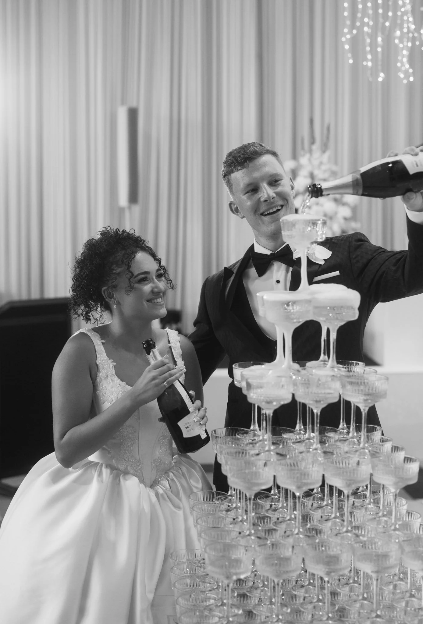wedding-couple-pouring-champagne-tower-photographer.jpg