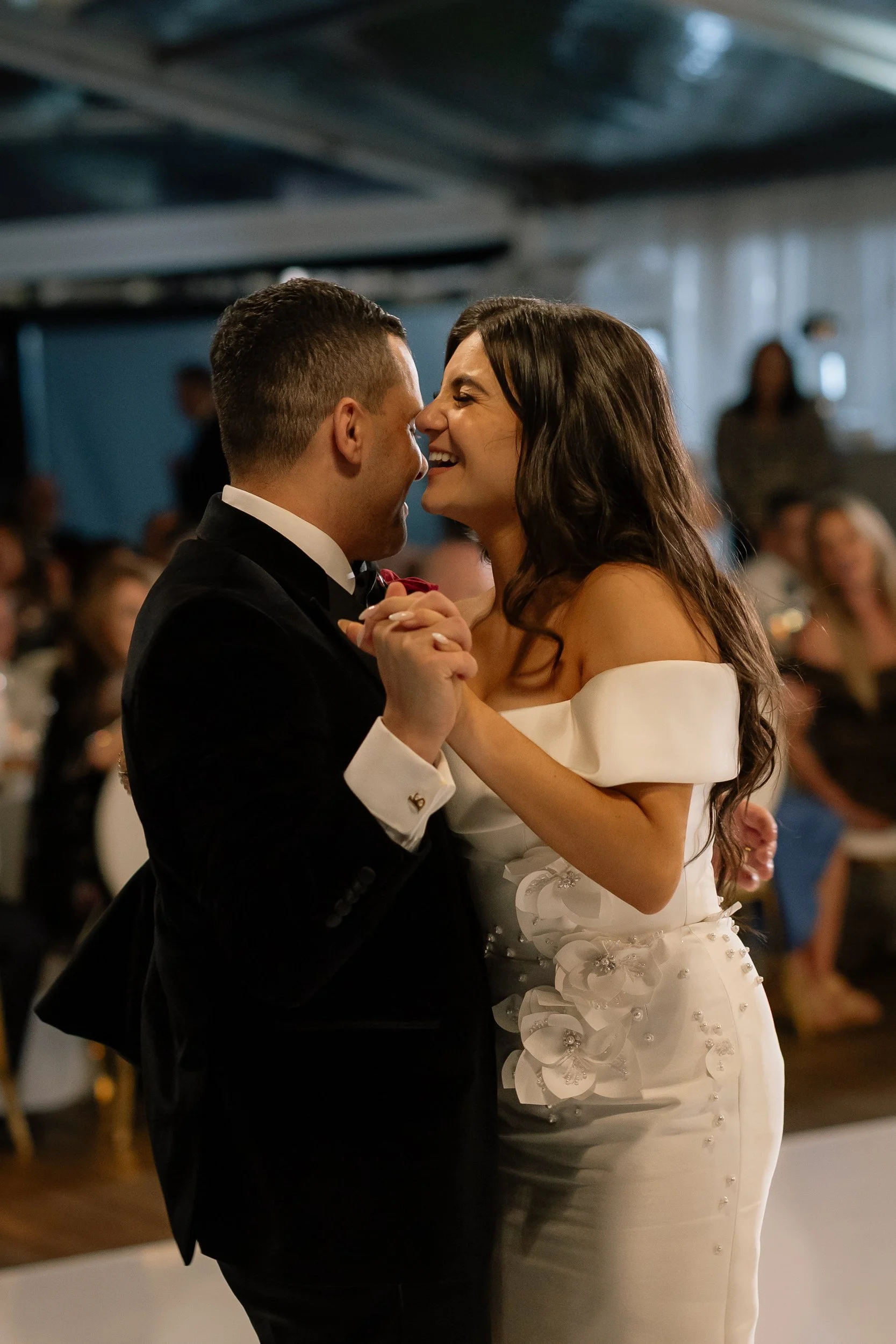 Laughing bride in an off-shoulder floral appliqué gown shares her first dance with her groom during a Perth wedding