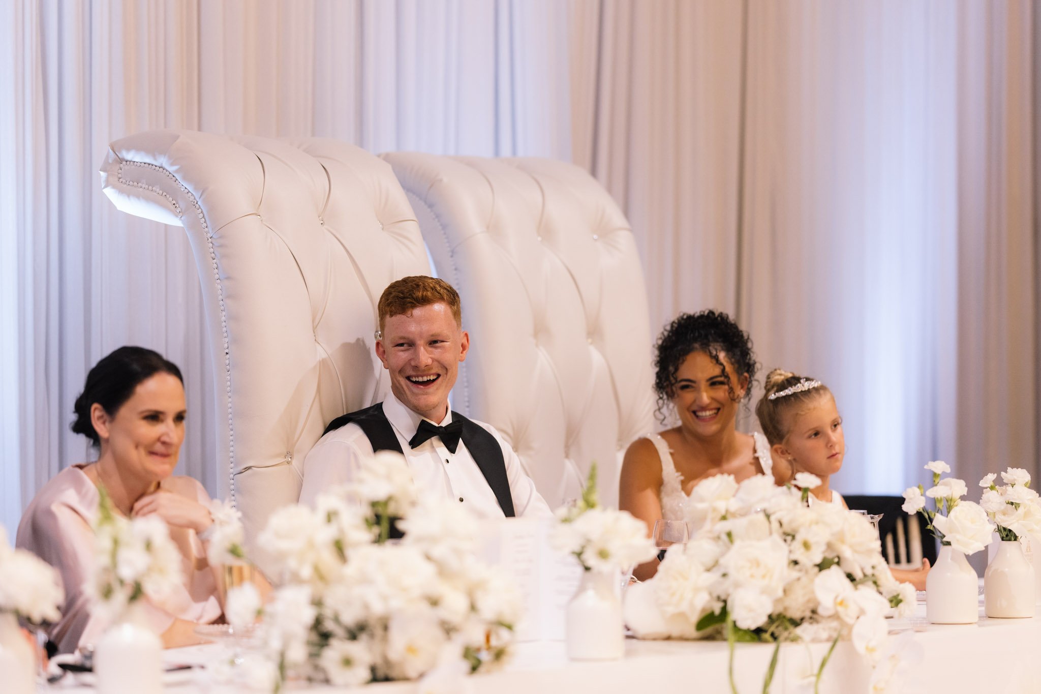 wedding-photographer-groom-laughing-head-table.jpg