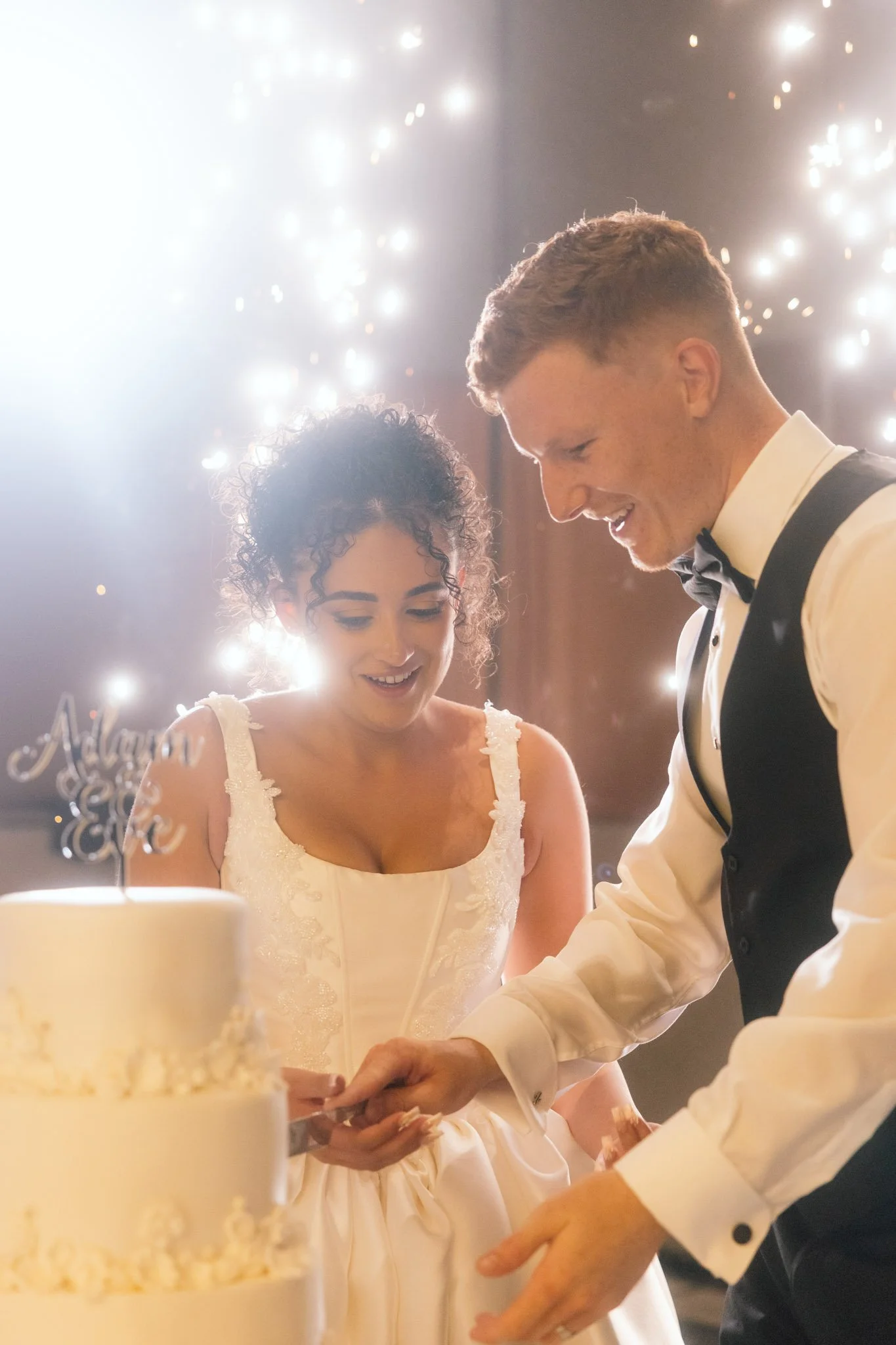 bride-groom-cutting-wedding-cake-photographer.jpg