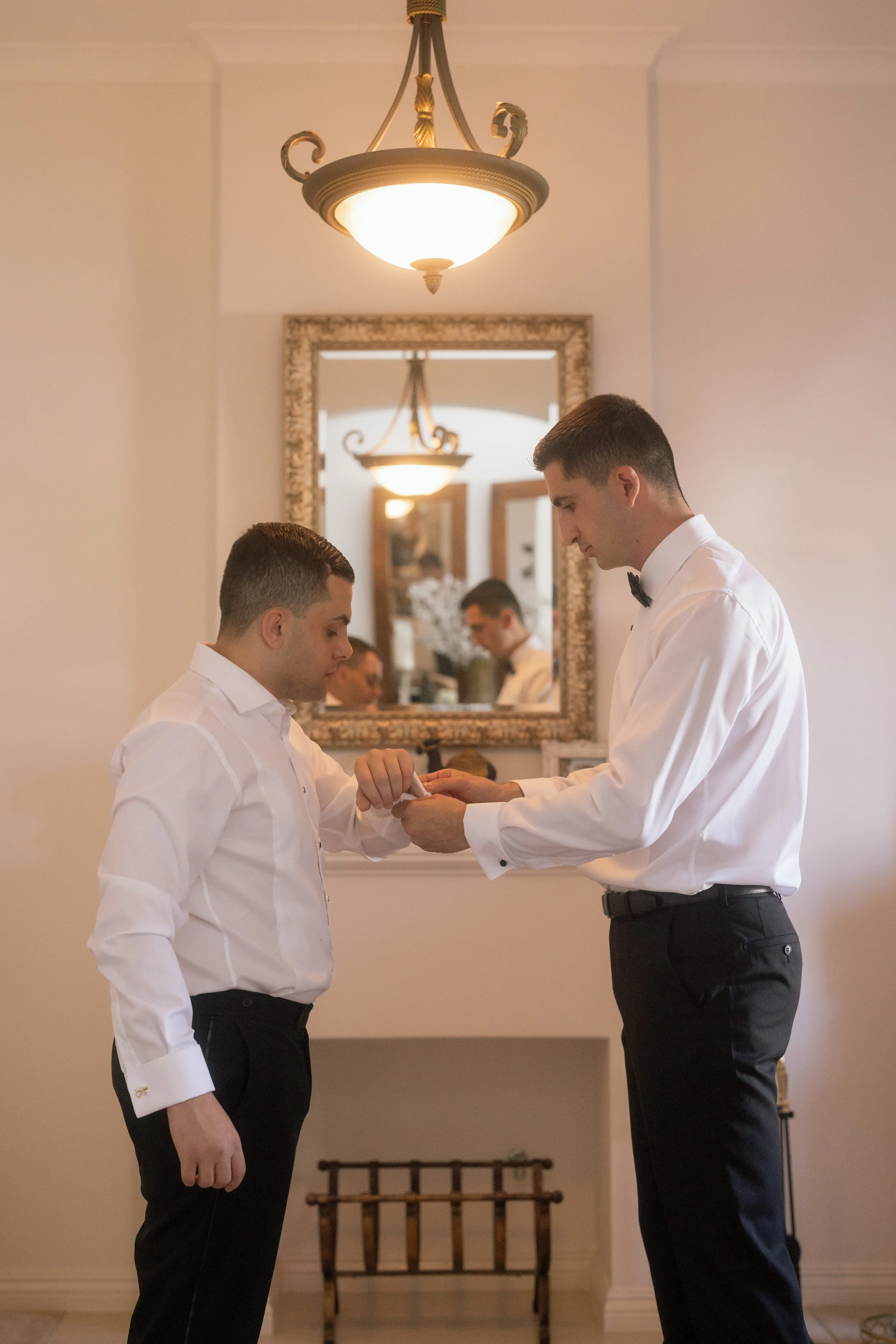 Bride and groom smile during a Catholic church ceremony in Perth, framed by lush burgundy and blush floral arrangements