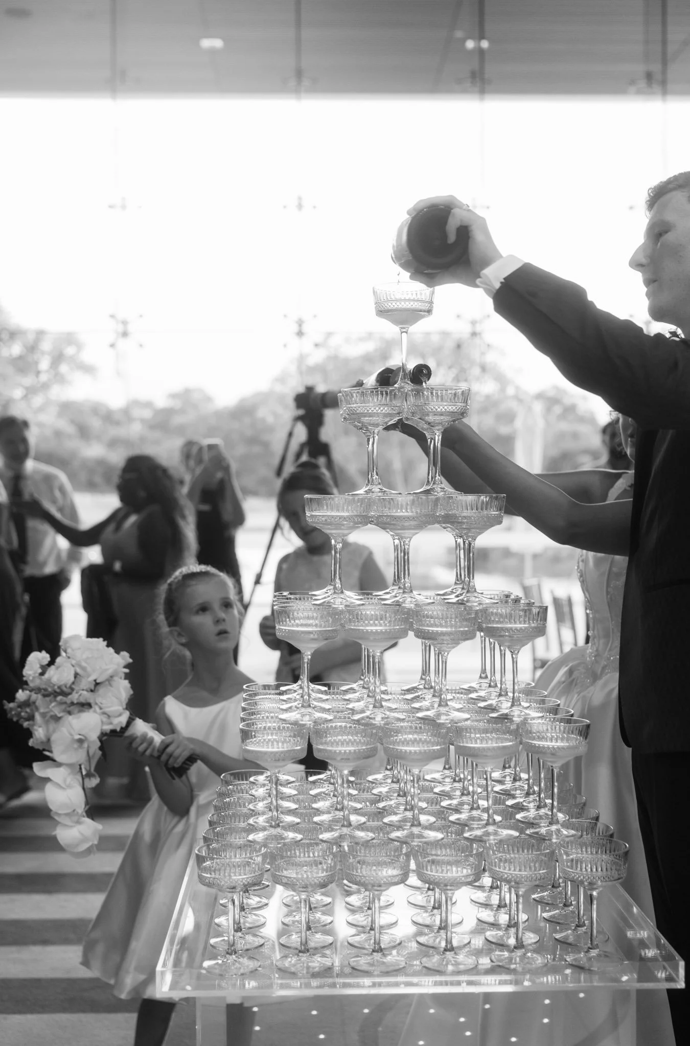 wedding-photographer-pouring-champagne-tower-reception.jpg