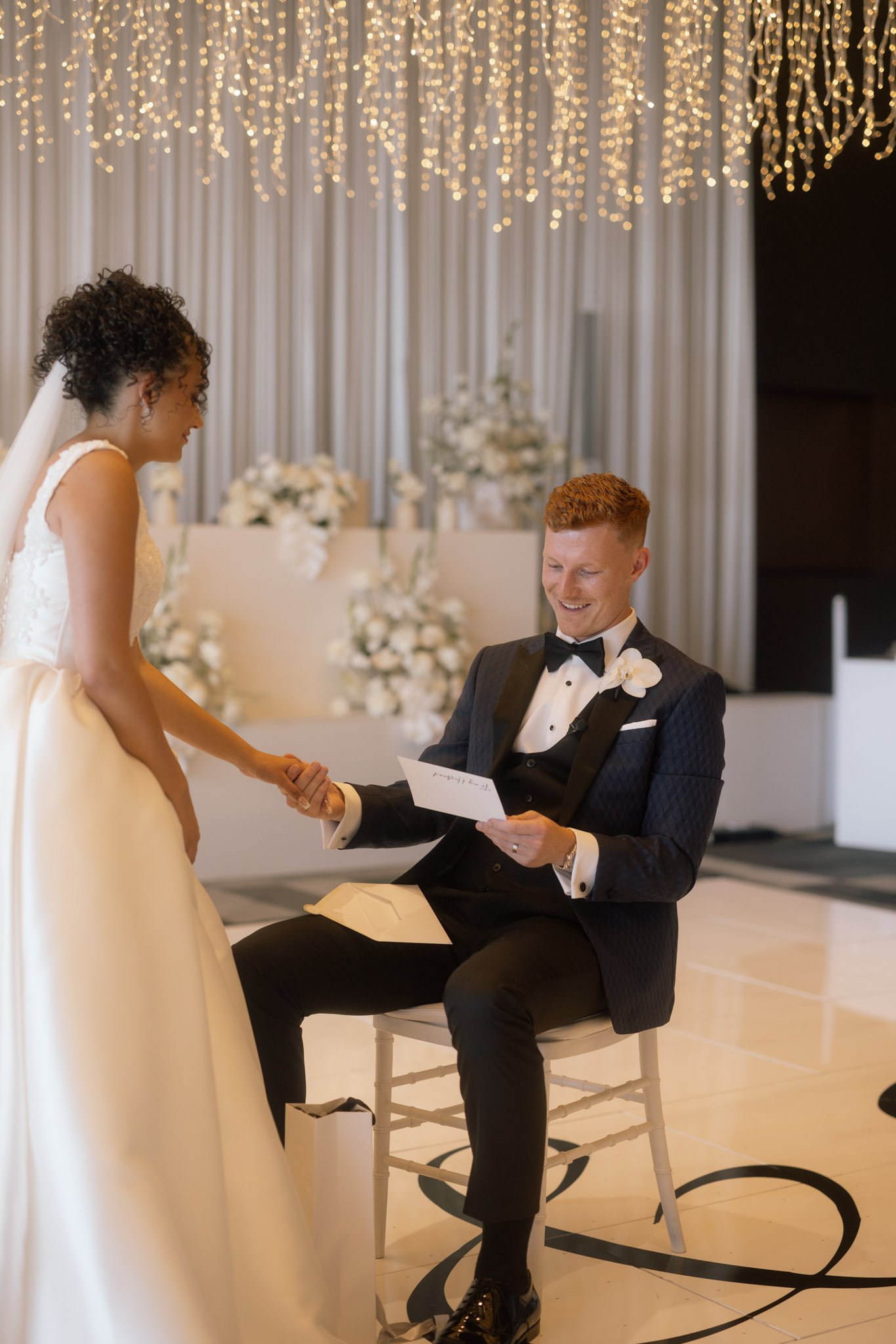 groom-reading-letter-wedding-photographer-videographer.jpg